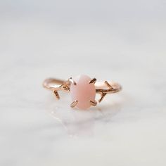 Our dainty Pink Opal Ring is part of our new Birthstone Ring Collection! This beautiful, yet delicate ring is made with genuine, untreated Pink Opal. The October Birthstone represents hope + compassion. Not to mention, the unique look of the whimsical vine ring setting will ensure endless compliments. If you're looking for a ring with style, quality and true meaning, look no further.----------------------FEATURES◊ Oval shaped, brilliant cut faceted genuine Pink Opal stone (6mm x 8mm)◊ Choice of October Stone, Pink Stone Ring, Pink Opal Ring, Moonstone Engagement Ring Set, Pink Stone Rings, Vine Ring, Dainty Rings, October Birthday, Moonstone Engagement