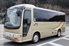 a tan bus parked in a parking lot