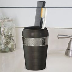 a toothbrush holder is sitting on the sink counter