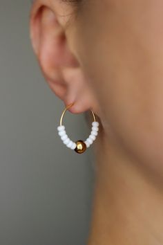 Lovely minimalist earrings with white glass seed beads,gold tone sphere beads and gold tone stainless steel round hoop earrings. Earring hooks are from nickel free and lead free metal. Perfect jewelry for everyday wear or a great gift for someone special! Diameter of hoops is 20 mm. Other earrings of my shop you can see here: https://www.etsy.com/shop/NaTavelli?section_id=13757927 Thanks for visit. Minimalist Beaded Earrings, Gold Hoop Earrings With Spacer Beads, Hypoallergenic White Beaded Earrings For Everyday, Minimalist Hoop Earrings With Round Beads, White Tiny Beads Small Hoop Earrings, White Hoop Earrings With Tiny Beads, White Tiny Beaded Small Hoop Earrings, White Small Hoop Beaded Earrings With Tiny Beads, White Beaded Hoop Earrings With Tiny Beads