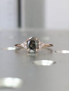 a close up of a diamond ring on a table