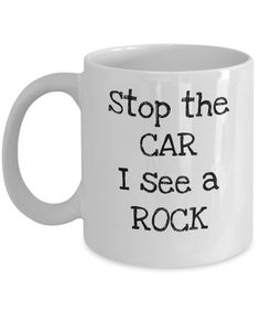 a white coffee mug that says stop the car i see a rock