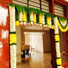 an entrance decorated with flowers and greenery for a wedding or special occasion to be attended