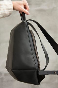 Comfortable leather backpack. Special and unique shape, a convenient construction is closed of a metal zipper-lock. Leather's outer distinctive feature - vintage look. It takes bends, creases or scratches if you hook on something. Scratches are easy to remove by rubbing the place with some soft fabric or even a finger. The leather is of high quality, keeps shape perfectly. This city-style travel bag is the perfect size for any of your daily essentials. In the middle of the backpack there is a po Modern Softback Backpack, Modern Standard Backpack For Daily Use, Modern Leather Backpack With Adjustable Strap, Modern Backpack With Zipper Pocket, Modern Backpack For Everyday Use, Modern Backpack With Adjustable Strap, Modern Leather Softback Backpack, Modern Everyday Backpack, Modern Leather Shoulder Backpack With Zipper