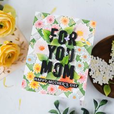 a mother's day card with flowers on it