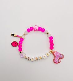 Festive, fun, lightweight Barbie bracelet for kids. Made with a mixture of pink, clear, and gold filled beads in a mixture of sizes 4 mm and 6 mm, star beads, and a smiley face charm,lipstick charm, and barbie charm on stretch cord. These festive, trendy, fun bracelets are customized just for you and those special people in your life! Each one is perfect on its own or layered with even more bracelets! Message me for layering and stack ideas! These are perfect gifts for birthdays or holidays, gif Themed Pink Bracelets For Birthday, Pink Themed Birthday Bracelets, Personalized Pink Charm Bracelet, Adjustable Pink Charm Bracelet For Party, Pink Adjustable Charm Bracelet For Parties, Pink Bracelet For Party Favors, Trendy Pink Beaded Bracelets For Party, Pink Beaded Stretch Bracelet For Party, Pink Beaded Jewelry For Party Favors