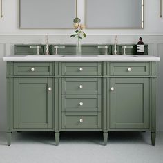 a bathroom with two sinks and mirrors on the wall