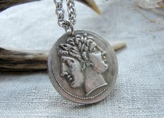 This gorgeous necklace I created using copy of ancient Roman coin with Janus  Coin diameter 2.4 cm or 1 inch Please choose a necklace length: 1. Necklace adjusts from 43 to 53 cm or from 17 to 21 inches 2. Necklace adjusts from 51 to 61 cm or from 20 to 24 inches 3. Necklace adjusts from 58 to 68 cm or from 23 to 27 inches 4. Necklace adjusts from 63 to 73 cm or from 25 to 28 inches It is a copy of a the Roman Republic ancient silver coin. Obverse: Laureate head of Janus or the twinned Dioscuri. Symbolic Bronze Jewelry With Coin Pendant, Symbolic Handmade Coin Necklaces, Symbolic Etched Coin Jewelry, Engraved Symbolic Coin Necklace, Symbolic Coin Shaped Locket Jewelry, Silver Symbolic Medallion Necklace, Symbolic Silver Medallion Necklace With Coin Pendant, Sterling Silver Amulet Coin Necklace, Symbolic Coin Necklace With Large Round Pendant