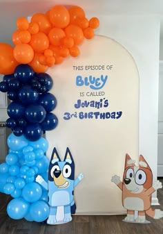 this is an image of a birthday party with balloons and cartoon characters on the wall