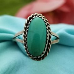 NATIVE AMERICAN Sterling Silver Oval Turquoise Split Ring-Beautifully Crafted.  Made in the 1960s.  This Bohemian Style Ring features a Large, Natural Turquoise Stone that is Half Bezel Set in a Solid and Stamped Sterling Silver Ring with a Unique Twisted Rope Border Design.  The Turquoise measures 13mm in Length The Ring Itself measures 11/16'' in Length x 7/16'' Wide Split Shank Size US 7 Weighs 2.70 Grams Southwestern Green Oval Turquoise Ring, Handmade Vintage Oval Turquoise Ring, Vintage Handmade Oval Turquoise Ring, Handmade Vintage Turquoise Oval Ring, Bohemian Oval Turquoise Collectible Ring, Vintage Turquoise Oval Ring, Western Style Untreated Oval Turquoise Ring, Untreated Adjustable Oval Turquoise Ring, Adjustable Oval Turquoise Western Ring