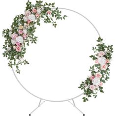 a white circular stand with flowers and greenery on the top, in front of a white background