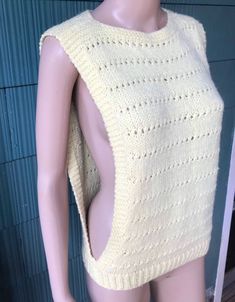 "Amazing vintage 70's pale yellow crochet tank top. Square shape, high neckline. Open at the armpit to the bottom edge. Size medium. Acrylic feel. No tags, handmade. Excellent vintage condition! So perfect. Will best fit small/medium. Measurements laying flat: fabric stretches. Pit to pit/waist: 16-18\" length: 22.5\"" Fitted Sleeveless Crochet Top With Knit Fabrication, Fitted Knit Vest For Spring, Vintage Sleeveless Crochet Top, Vintage Crochet Sleeveless Top, Vintage Fitted Sleeveless Crochet Top, Fitted Vintage Sleeveless Crochet Top, Vintage Sleeveless Crochet Top For Spring, Yellow Sleeveless Crochet Top, Yellow Crochet Sleeveless Top