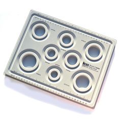 a metal tray with holes and circles on it