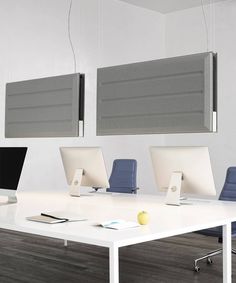 three computers are sitting on a white desk