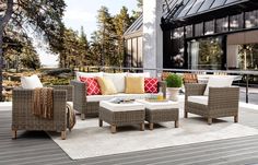 an outdoor living area with wicker furniture