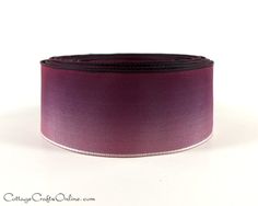 a purple and black ribbon on a white background