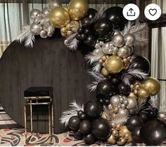 a black and gold party decoration with balloons