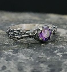 Introducing the enchanting Amethyst Stone Silver Ring by RedFoxSilverCrafts! 🌹✨ Immerse yourself in the captivating beauty of this exquisite ring. Crafted with sterling silver, it showcases a stunning amethyst stone at its center, radiating elegance and spirituality. The intricate design features delicate rose figures that gracefully adorn the band, adding a touch of romance to this timeless piece. 💎 The vibrant purple hue of the amethyst is believed to promote clarity and inner peace, making Sterling Silver Hallmarked Amethyst Promise Ring, Lavender Hallmarked Ring Jewelry, Nature-inspired Purple Sterling Silver Jewelry, Fine Jewelry Lavender Hallmarked Rings, Sterling Silver Amethyst Promise Ring, Hallmarked Amethyst Crystal Promise Ring, Hallmarked Amethyst Crystal Ring For Promise, Amethyst Solitaire Ring For Promise, Hallmarked Amethyst Ring In Sterling Silver