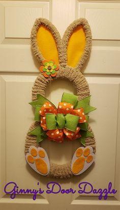 a door hanger decorated with an easter bunny's ears and orange polka dots