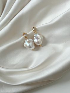 Natural high quality freshwater pearl drop earrings in 14k gold filled clasp.  The earrings are delicate, elegant and lightweight. Perfect for any occasion. All of our products can be customised.  This Earrings are: - Handmade - Water resistant and tarnish free -The size of the pearls is of approximately 1.5cm. Materials: - 100% Natural freshwater Pearls - 14k Gold filled materials which are of used on making our jewellery tend to be more tarnish-resistant than gold plated options, ensuring the 14k Gold Filled Pearl Drop Earrings For Anniversary, 14k Gold-filled Pearl Pendant Earrings For Wedding, Elegant Briolette Teardrop Earrings, Classic Pearl Pendant Earrings In 14k Gold Filled, Elegant Pearl Charm Earrings In 14k Gold Filled, Elegant 14k Gold-filled Earrings With Pearl Charm, Elegant 14k Gold Filled Earrings With Pearl Charm, Elegant 14k Gold-filled Teardrop Earrings, 14k Gold Filled Elegant Teardrop Earrings