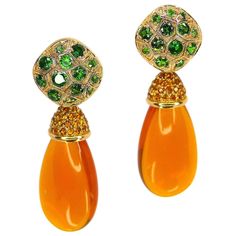 Thomas Leyser is renowned for his contemporary jewellery designs utilizing fine gemstones. This 18k red gold (3.45g) pair of earrings is set with 2x fine Mexican Fireopal Brioletts (28x13x8mm, 29.49ct) + 70x Mandarin Garnets (round, 1.3mm, 0.70ct) + 18k red gold (8.50g) clips set with 26x Tsavorites (round 1.4mm, 1.56ct). Both parts can be separated. Fire Opals, Vintage Drop Earrings, Contemporary Jewelry Design, Coat Women Fashion, Sparkle Jewelry, Bead Embroidery Jewelry, Bridal Jewellery Indian, Embroidery Jewelry, Contemporary Jewellery