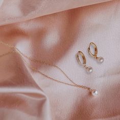 This exquisite handcrafted pearl necklace and huggie hoops gift set are a timeless fusion of elegance and style.  The necklace features a lustrous pearl delicately hanging on a chain, creating a classic yet modern look. Paired with my sleek Huggie diamond cz hoops adorned with subtle detailing, this set is the perfect balance of sophistication and versatility.  Elevate any outfit with this thoughtful and beautifully crafted ensemble, making it an ideal gift for those who appreciate the finer thi Feminine Gold Jewelry With Pearl Charm, Feminine Hypoallergenic Gold Jewelry, Hypoallergenic Feminine Gold Jewelry, Elegant Jewelry Sets With Clavicle Chain, Delicate Hoop Jewelry As Gift, Delicate Hoop Jewelry For Gift, Rose Gold Jewelry With Pearl Drop, Rose Gold Pearl Drop Jewelry, Classic Pearl Hoop Jewelry