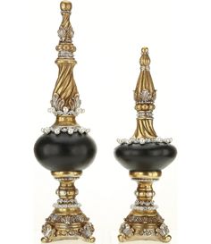 a pair of black and gold candlesticks with crystal decorations on each candle holder