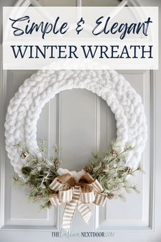 a simple and elegant winter wreath hanging on the front door