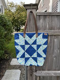 Flying Star Block Quilted Tote Bags with genuine leather handles and a zipper top to hold all your items safe and sound. Both bags have an interior zipper pocket for your valuables and some slip pockets to keep you organized.  Blue Bag :  The star is made of Liberty of London fabric and the dark blue is a Carolyn Feidlander fabric.  Lined with a neutra fabric. Approximate dimensions are: width accross the top - 18" height - 17" depth - 7" Maroon Bag:   SOLD    Super cute green and pink calico print is used for the star. It is lined with a green fabric. Appoximate dimensions are: width accross the top - 17" height - 14" depth - 5.5" Blue Tote Weekender Bag With Zipper Closure, Daily Use Travel Bag With Zipper Closure, On-the-go Pouch Travel Bag With Zipper Pocket, Crossbody Travel Bag For Daily Use, Everyday Rectangular Travel Bag With Zipper Pouch, Blue Tote Travel Bag With Zipper Closure, Zipper Closure Travel Bag Pouch For On-the-go, On-the-go Travel Bag With Zipper Closure, Daily Use Travel Bag With Zipper Pocket