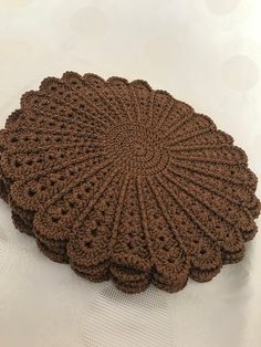 a brown crocheted doily sitting on top of a table