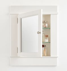 the medicine cabinet is white and has glass shelves on both sides, with one door open