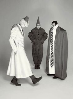 three men in costumes standing next to each other