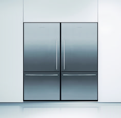 two stainless steel refrigerators sitting side by side in a white room with shiny flooring