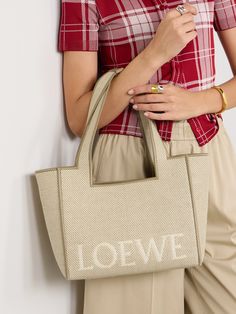 Loewe's 'Font' tote is jacquard-woven with the house's moniker on the front. The perfect holiday bag, it's made from canvas, outlined with leather and has an open design that offers space for a wallet, camera, shades and small sunscreen. Loewe Cushion Tote, Diy Fabric Purses, Flat Dress Shoes, Embroidered Canvas, Floral Dresses Short, Fabric Purses, Holiday Bag, Embroidered Leather, Shoulder Bags For Women