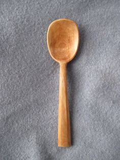 a wooden spoon sitting on top of a gray surface