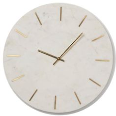 a white clock with gold hands on a white background