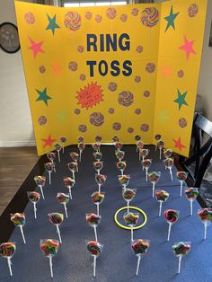 a table topped with lollipops on top of a blue cloth covered floor