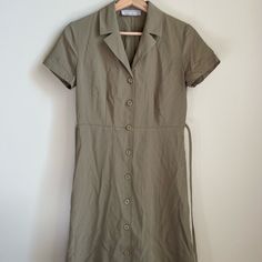 Great Quality Mini Dress With Tie Back. Olive Green Color And Button Up Front. Brand New (No Tags) And Never Worn. Classic Summer Mini Dress With Button Closure, Classic Mini Dress With Button Closure For Spring, Classic Mini Dress With Button Closure For Summer, Casual Everlane Dresses For Daywear, Classic Buttoned Mini Dress For Summer, Classic Mini Dress With Buttons For Summer, Classic Short Sleeve Mini Dress With Buttons, Chic Everlane Midi Dress, Casual Fitted Shirt Dress With Covered Buttons