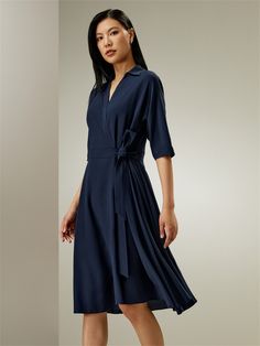 This flowing umbrella hem wrap dress features a V-neck and half-loose sleeves, and is carefully designed to fit all sizes. It has a front tie belt that accentuates the waistline, adding a twist and elegance to this classic casual design. Silk Crêpe de Chine Elegant Belted V-neck Dress With Short Sleeves, Blue Wrap Dress With Belt, Blue Belted Wrap Dress, Flowy Midi-length Wrap Dress With Tie Waist, Flowy Belted Wrap Dress, Spring Half Sleeve Belted Dress, Flowy Dresses With Tie Waist For Work, Summer Midi Dress With Belt And 3/4 Sleeves, Elegant Summer Belted Dress With Tie Fastening