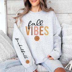 Get ready for some basketball action and show your love for the game with this cutie! Not found in stores so be UNIQUE and grab this cute and cozy sweatshirt today!  Gildan Brand Unisex Sweatshirt .: Made with a medium-heavy fabric blend of 50% cotton and 50% polyester (8.0 oz/yd² (271.25 g/m²) .: The classic fit along with the crew neckline deliver a comfy wearing experience with a clean-cut style.  .: Say goodbye to itchiness thanks to the gray, pearlized tear-away label.  .: Made using 100% e Fall Team Spirit Sweatshirt With Ribbed Cuffs, Fall Athletic Heather Sweatshirt With Ribbed Cuffs, Fall Athletic Heather Sweats With Ribbed Cuffs, Athletic Heather Sweatshirt With Ribbed Cuffs For Fall, Sporty Athletic Heather Sweatshirt For Fall, Athletic Heather Fan Apparel Sweatshirt For Fall, Trendy Letter Print Sweatshirt For Sports Season, Fall Sports Sweater With Graphic Print, Fan Apparel Sweatshirt With Ribbed Cuffs For Fall