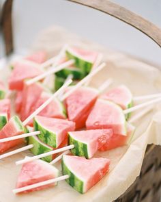 watermelon slices on sticks with toothpicks in them