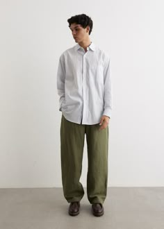 Inspired by American workwear, Tokyo-based designer Daiki Suzuki imagined Engineered Garments to be a label that values durability and structured silhouetting. Crafted from an cotton ripstop, the Officer Pants are cut to a loose, classic fit. - Cotton ripstop- Concealed drawstring waistline- Zip fly with button closure- Side and back pockets- Classic cut- Loose fit Materials:100% Cotton. Care:Dry clean only. Sizing: Item fits true to size. Model wears a size M and is 188cm/6'2". Men Loose Outfit, Japanese Man Fashion, Ametora Style Men, Clean Outfits Men, Japanese Americana Fashion Men, Workwear Outfit Men, Japanese Street Style Men, Japanese Fashion Men, Men Japanese Style