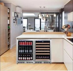 a kitchen with an island and wine cooler in it