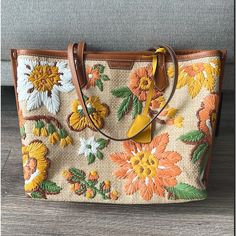 New With Tags, With Original Package. Get Vacay-Ready Style With This Woven Straw Tote Featuring Colorful Embroidered Flowers And A Roomy Interior. Size: 13.55" L X 11.16" H X 5.34" D Top Zip Closure Dual Shoulder Straps Exterior Features Woven Straw With Floral Embroidery And Leather Trim Lined Interior Textile And Leather Exterior/Cotton Lining Mannequin's Height For Scale: 5'9" Designer Embroidered Tote Bag, Designer Embroidered Shopping Bag, Designer Embroidered Bags For Shopping, Designer Embroidered Shoulder Bag For Travel, Designer Embroidered Bags For Daily Use, Brown Bags With Embroidered Logo For Shopping, Tory Burch Perry Tote, Tory Burch Ella Tote, Orange Tote Bags