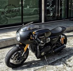 a black motorcycle parked in front of a store