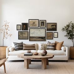 a living room filled with lots of furniture and pictures on the wall above it's coffee table