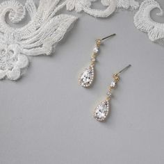 Enhance your bridal ensemble with these exquisite wedding earrings featuring a pave set elongated pear drop, delicately suspended from petite round and marquise CZ stones.They are 1.5 inches long, post pierced backs, rhodium, rose gold or gold plated, grade AAA CZ stones, lead, cadmium, and nickel free. Pear-shaped Teardrop Earrings With Diamond Accents For Wedding, Gold Linear Earrings With Sparkling Stones For Wedding, Sparkling Linear Drop Earrings For Wedding, Gold Teardrop Earrings With Diamond Accents For Wedding, Wedding Long Drop Linear Earrings With Diamond Accents, Classic Drop Linear Earrings For Wedding, Long Drop Linear Earrings With Diamond Accents For Wedding, Classic Cubic Zirconia Linear Earrings For Wedding, Classic Teardrop Linear Earrings For Wedding