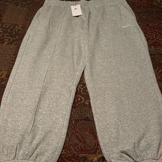 New! Womens Nike Sportswear Fleece Lined Loose Fit Mid Rise Elastic Ankle Sweatpants. Grey Color Way. Womens Size 2x Waist 19.5 Rise 13 Inseam 28.25. Two Hand Pockets. Pristine Condition. See All Photos Nike Loose Fit Sweatpants, Grey Sweatpants Nike, Nike Fleece Sweatpants, Nike Grey Sweatpants, Grey Nike Sweatpants, Sweatpants Nike, Sweatpants Grey, Bday Wishlist, Wide Leg Sweatpants