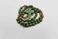 Wooden Rosaries, Wood Beads, Handmade Wood Rosary, Missionary Rosary, Handmade Rosary, Rosary made of Wood, Rosary Beads, prayer beads Wooden Rosary Beads Handmade Handmade these green wooden rosary beads have wood on 10 Hail Mary beads and light brown wood on the Our Father beads. Woven together with a brown chord. Rosary is 42.50 cm or 16.7 Inches long. Wooden cross engraved with the Chi-Rho symbol. The Chi (X) and (P) are the first two letters of Christ in Greek, Christos. Thank you for looki Handmade Spiritual Rosary With Oval Beads, Spiritual Rosary With Large Beads As Gift, Handmade Spiritual Rosary With Cross, Adjustable Rosary With Large Beads As Gift, Adjustable Large Beads Rosary As Gift, Bohemian Beaded Cross Rosary, Beaded Cross Rosary For Meditation, Adjustable Green Rosary With Round Beads, Meditation Cross-shaped Beaded Rosary