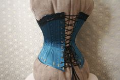 *THIS IS A MADE-TO-ORDER ITEM.* It's usually about 4-6 months between when you order your corset and when it arrives on your doorstep. Selecting faster shipping services will not make me sew any quicker, sorry This corset does NOT come with the muslin prototype step, like my other corsets. You get to choose the colors, but all other details are fixed. (you could also opt-out of the lace and/or embroidery if you wanted.) This corset is a medium weight late-Victorian corset, made with 1 layer of c Fitted Corset With Boning For Costume, Fitted Bodice Corset With Boning For Costume, Fitted Overbust Bodice For Costume, Elegant Corset With Corset Back For Cosplay, Fitted Costume Corset Belt With Boning, Fitted Boned Bodice For Cosplay, Blue Fitted Underbust Corset Dress, Fitted Boning Corset Belt For Costume, Fitted Corset Belt With Boning For Costume